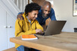 © ReeldealHD images - Son showing father his school grades on a laptop