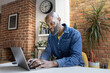© ReeldealHD images - Man Working on Laptop in Cozy kitchen