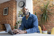 © ReeldealHD images - Thoughtful Man Working on Laptop at home in his kitchen