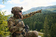 © .shock - Bearded Soldier in Tactical Gear Pointing Toward Distant Mountains During Forest Reconnaissance Patrol