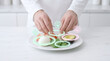 © Neuroillustrator3033 - Chef arranging food presentation with colorful sauces on plate
