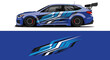 © AhzaArdiansyah - Sleek blue race car with bold graphic livery and rear wing on track.