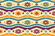 © opart - Ikat seamless pattern with colorful tribal floral motifs and ethnic geometric stripes in boho textile style for fabric wallpaper wrapping paper decor.