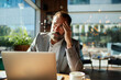 © Marko Geber - Stressed businessman working on laptop in coffee shop