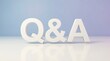 © DailyStock - Three-dimensional white q and a letters standing on a reflective white surface against a soft purple and blue gradient background, clean studio lighting