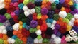 © OleksandrZastrozhnov - Assorted colorful pom pom balls covering fabric surface