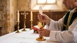 © Pixcellence - Priest holding host and chalice during the holy communion in a church. Clergyman performing eucharist ritual. Catholic mass celebration, religious faith and spiritual worship tradition.