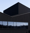 © ADDICTIVE STOCK - Modern candy factory exterior with dark metal facade