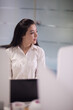 © .shock - Middle Eastern businesswoman in a modern open office during a startup meeting looking thoughtful