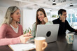 © ADDICTIVE STOCK - Coworking office team working with laptop and phone call