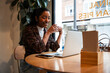 © ADDICTIVE STOCK - Young woman working on laptop in cafe with coffee break