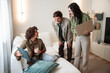 © ADDICTIVE STOCK - Friends planning home project with laptop in living room