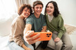 © ADDICTIVE STOCK - Friends taking a selfie on a sofa in bright home light