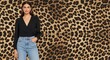 © Mbakar - Woman in fashionable attire posing against leopard print background