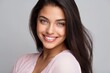 © Space Priest - Smiling young adult hispanic female with long hair and bright eyes in light pink blouse