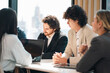 © chokniti - Business meeting team coworker office discussion planning strategy corporate workspace collaboration professional business meeting with diverse team coworker modern office during focused