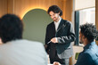 © chokniti - Business meeting office teamwork presentation leadership professional corporate discussion collaboration manager confident business meeting scene bright modern office with smiling male leader