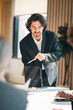 © chokniti - Business team meeting discussion collaboration presenting data analysis corporate teamwork diverse professionals planning strategy office communication partnership