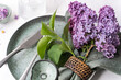 © Cavan Images - Spring dinner setting decorated with fresh lilac flowers on conc