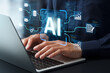 © tadamichi - AI engineering. Development and integration of artificial intelligence into business systems. Engineer building AI pipelines on laptop computer.