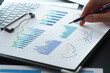 © tadamichi - Business financial analysis reports with graphs. KPI performance data and results. Businessman reviewing plan and developing growth strategy on desk.