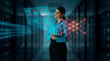 © Rendara Studio - Cybersecurity analyst woman reviewing network threat dashboard in server room