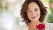 © Aillusionist - Beautiful mature American woman portrait holding red rose, soft smile, natural beauty, romantic lifestyle background