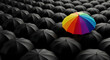 © Jabalenour - Colorful rainbow umbrella standing out from a crowd of black ones