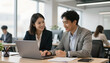 © NanzXy - Business Professionals Collaborating Over Laptop in Office: Teamwork Scene