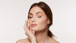 © master1305 - Woman with closed eyes touches cheek as fine white facial mesh covers face and neck on clean background. Ideal for skincare analysis, cosmetic treatments and beauty tech ads.