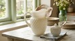© Alfatih - Vintage Hobnail Milk Glass Water Pitcher and Lidded Sugar Bowl on a Rustic White Wooden Table with Stacks of Plates and Wildflowers in a Country Kitchen Interior Natural Sunlight Decor