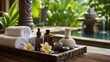 © XC Stock - Luxury spa treatment arrangement with towels oils flowers and hot stones beside tropical pool