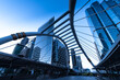 © nuttawutnuy - Modern structure bridge shape and building at train station in Bangkok, Thailand. Blue tone