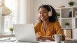 © sergiokat - Woman Wearing Headphones Works On Laptop