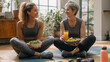 © Bangmunce - Fit Mother and Daughter Enjoying Healthy Meal Post Workout