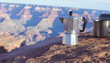 © asif - Moka pot espresso maker and metal cup on a rock overlooking the Grand Canyon