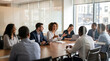 © FrameFlow - Business team meeting, diverse professionals around wooden table, female executive talking and gesturing, modern office conference room, corporate lifestyle
