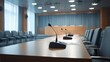 © Mary - Empty conference room with microphones set for a meeting in a modern office building during daylight hours