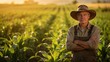 © Ardi - Portrait of Confident Senior Farmer Standing with Arms Crossed in Corn Field at Sunset