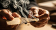 © MadeOka - Burning Paper Held in Hands Creating Smoke and Glowing Embers