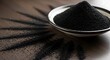 © Fio - Black sesame seeds in a bowl.