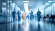 © CStock - A blurred view of healthcare professionals in a busy hospital corridor, conveying a sense of urgency and care.