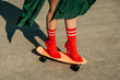 © Westend61 - Legs in red high heel balancing on an orange skateboard