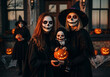 © Shagor - halloween costumes children and adults in skull makeup with pumpkins