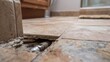 © TensorSpark - Exposed pipe under broken tile showing slab leak repair and concrete repair scenario with tool and damaged flooring.