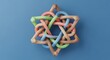 © Sahriar - Interlocking colorful 3D geometric shapes on blue background. Connection and unity concepts. Braided multicolored pipes forming a star object in a studio setting.