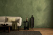 © FollowTheFlow - Stylish interior with copy space, design sofa, and personal accessories. Green limewash wall.