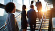 © Kateryna - Cinematic wide back view of silhouetted professional figures standing on a bright softly defocused modern office staircase mid conversation staircase meeting office discussion