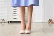 © Pixel-Shot - Legs of young woman in high heel shoes with callus patches at home