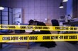 © Pixel-Shot - Police tapes and spy inspecting crime scene at night